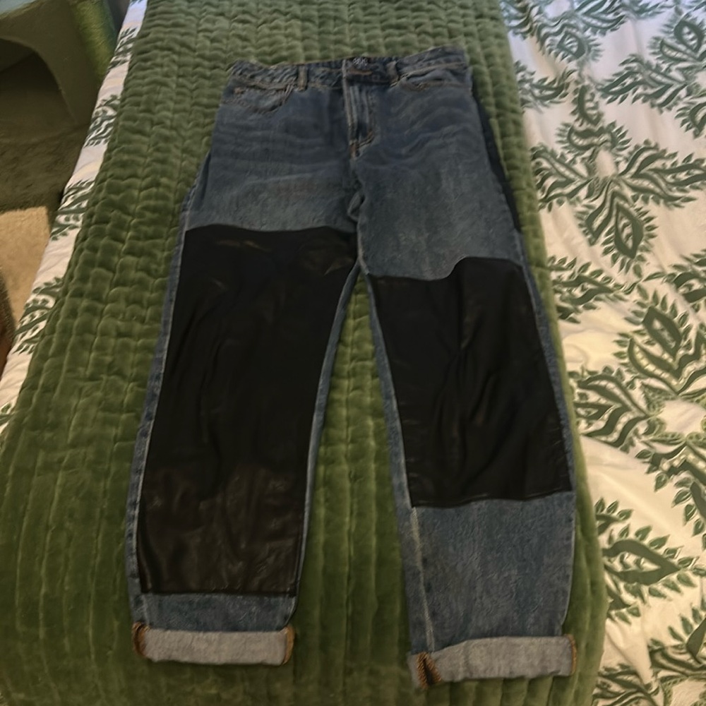 High rise jean. leather patching on the front and back.